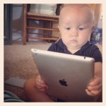 Baby reading a tablet